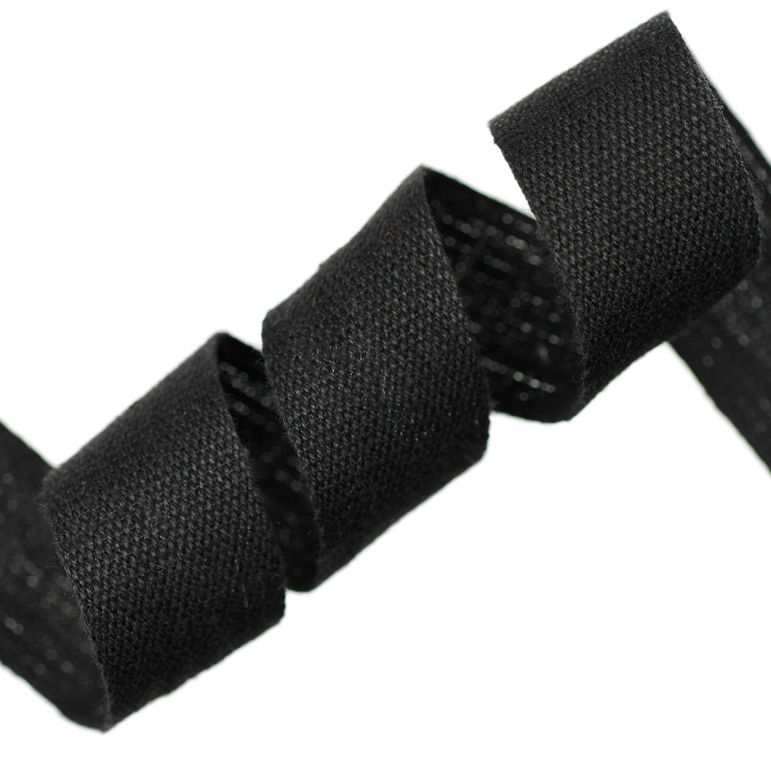 Close-up of black woven cotton tape on a white background