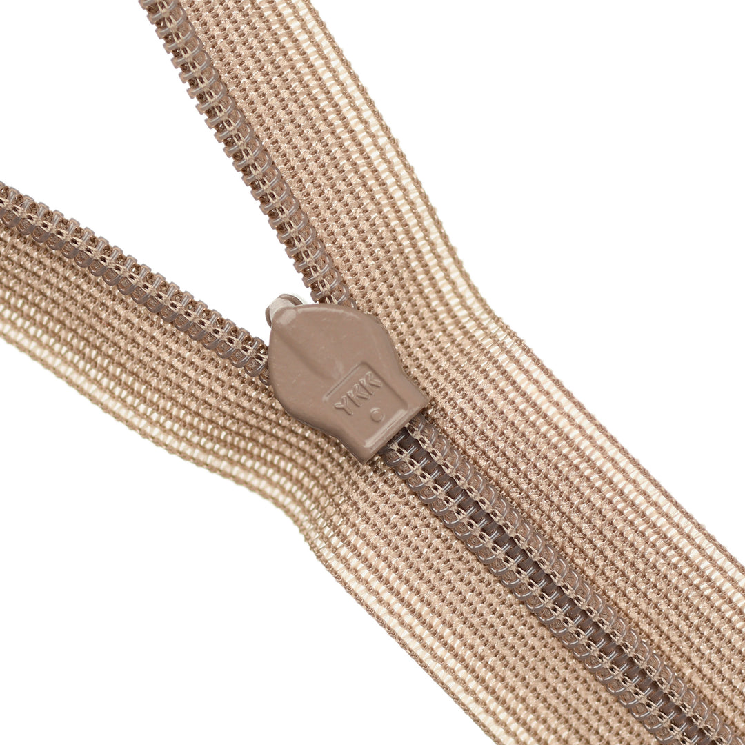 Close-up of a beige zipper on a white background