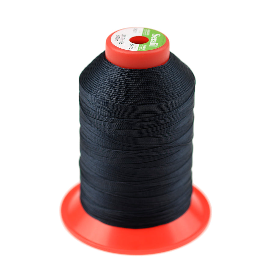 Spool of black thread on a red stand with a white background