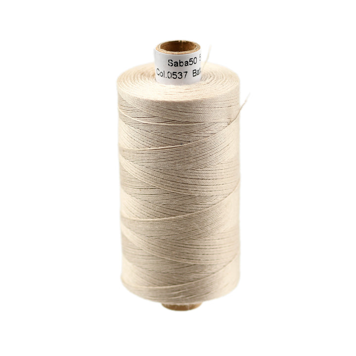 Spool of beige thread on a white background