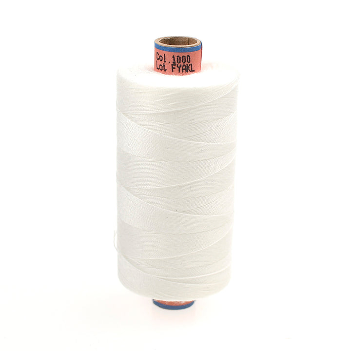 Spool of white thread on a white background