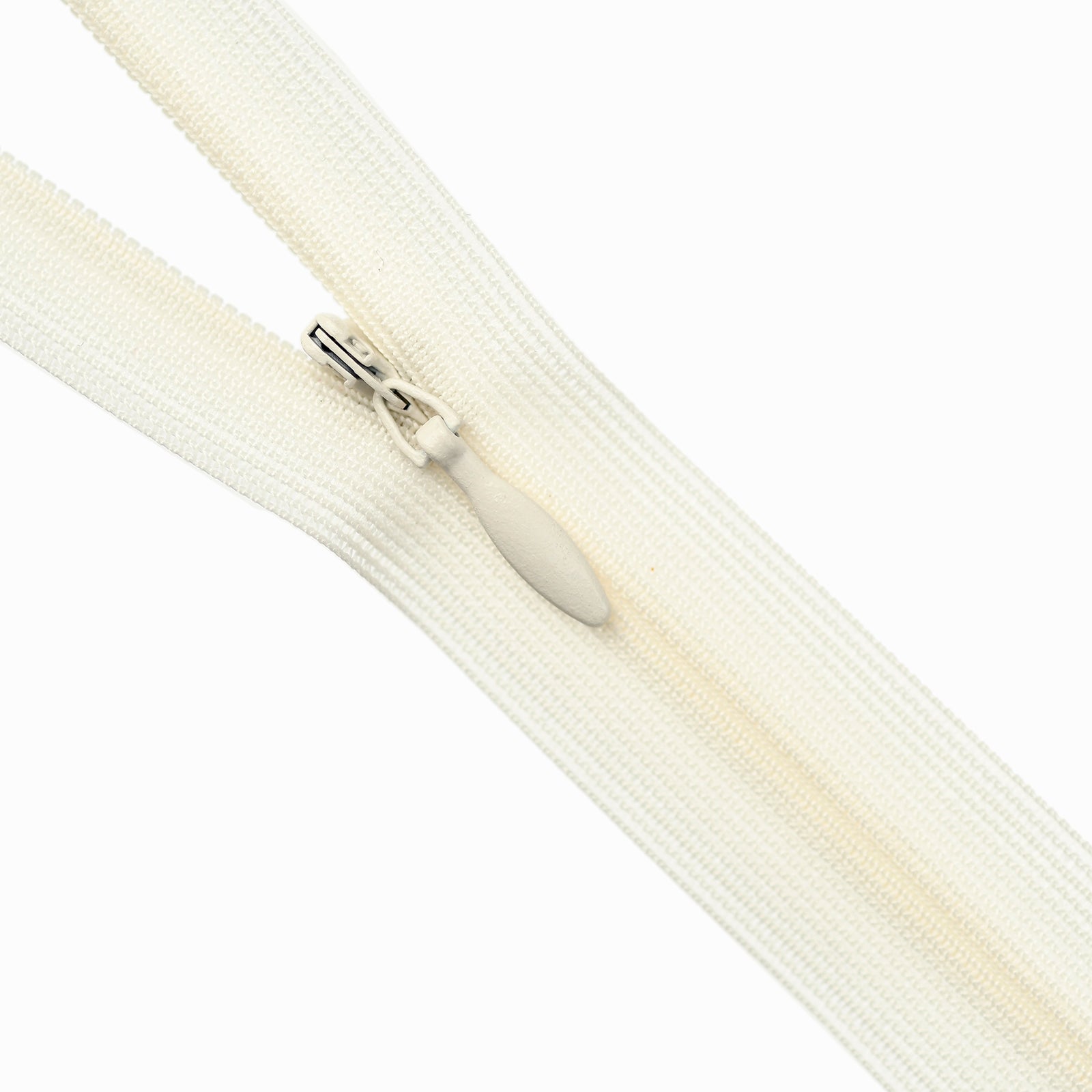 Close-up of an ivory zipper on a white background