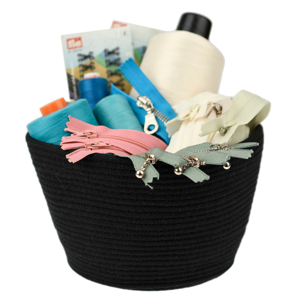 black woven basket with items for sewing