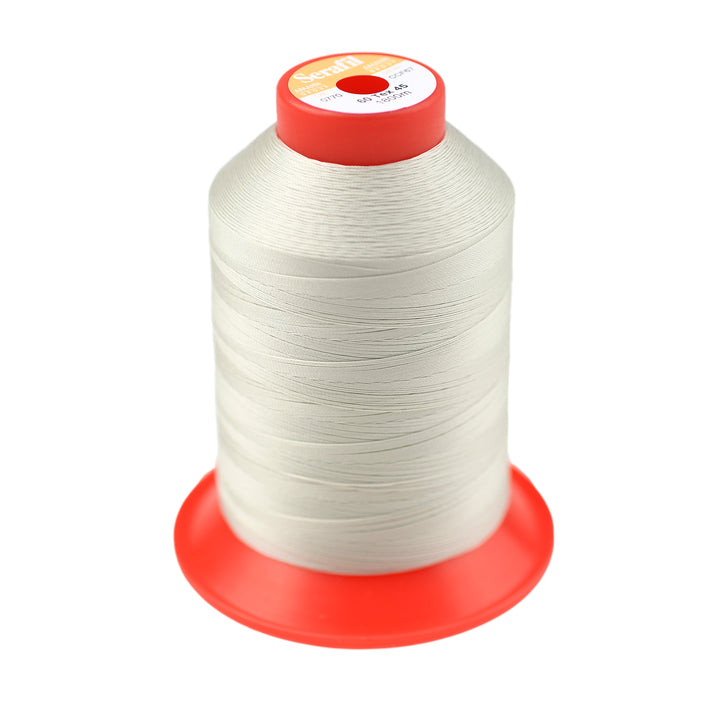 Spool of off-white thread against a white background