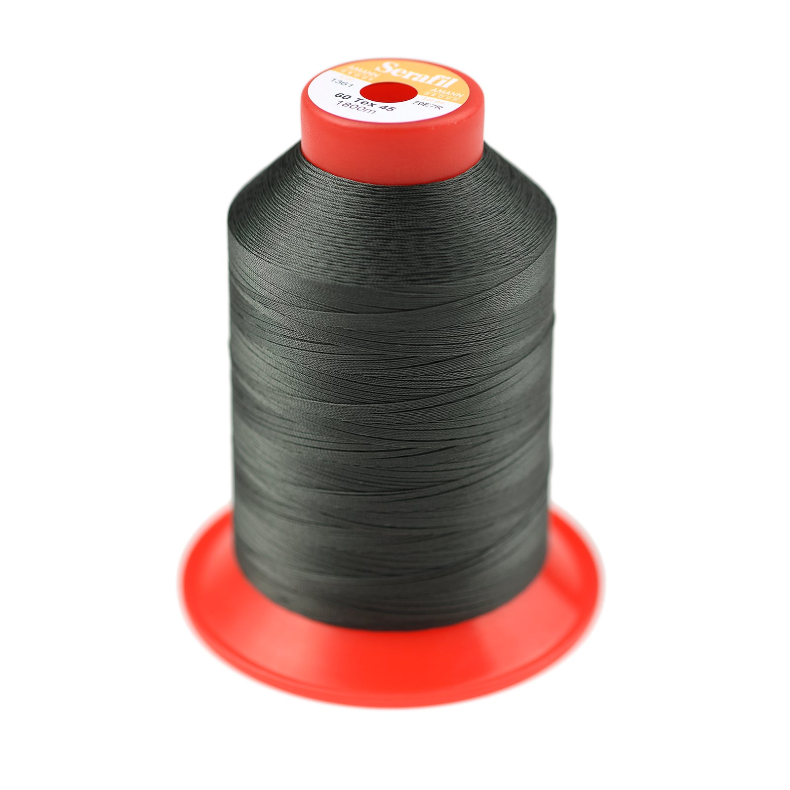Spool of dark green thread on a white background