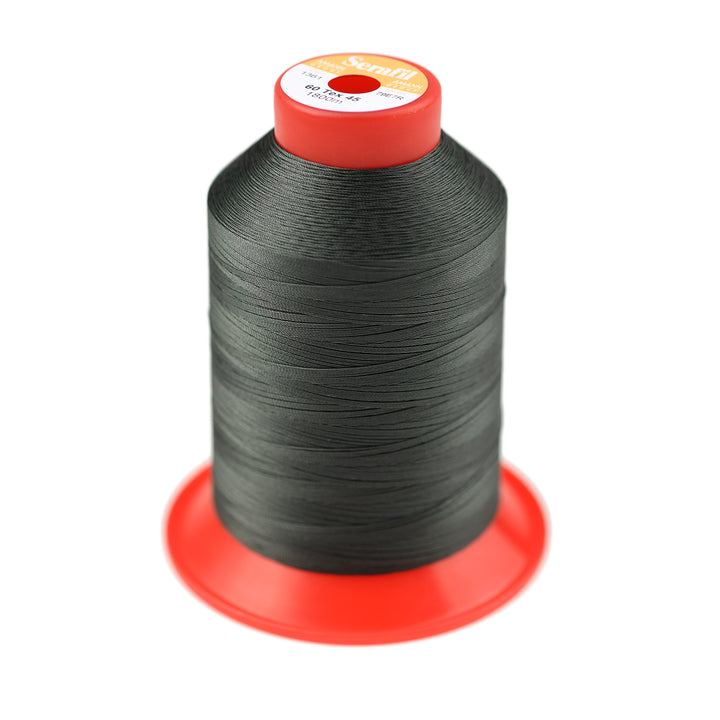 Spool of dark green thread on a white background